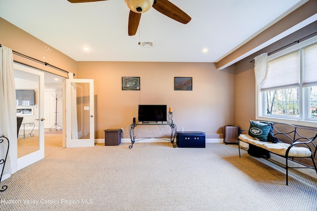 living area with baseboards, french doors, carpet floors, visible vents, and ceiling fan