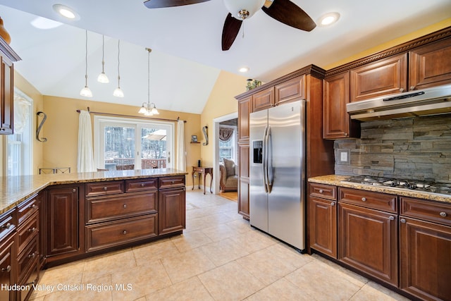 kitchen featuring a ceiling fan, appliances with stainless steel finishes, under cabinet range hood, backsplash, and lofted ceiling