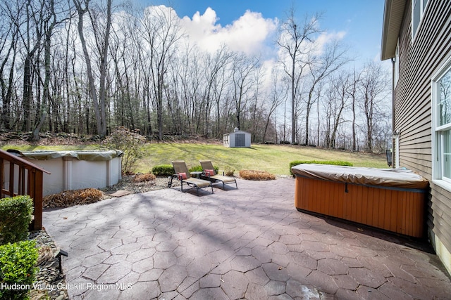 view of patio / terrace featuring an outdoor structure, a swimming pool, a hot tub, and a storage unit
