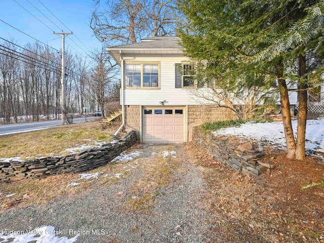 view of snow covered exterior featuring a garage