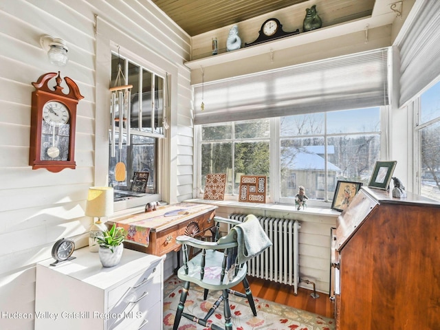 sunroom featuring wooden ceiling and radiator