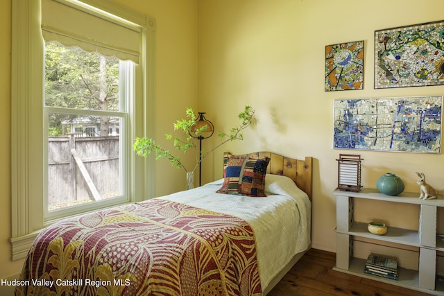 bedroom featuring hardwood / wood-style flooring and baseboards