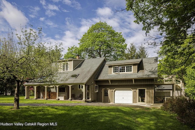 view of front of property featuring covered porch, board and batten siding, and a front yard