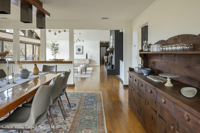 dining area with a chandelier and light hardwood / wood-style flooring