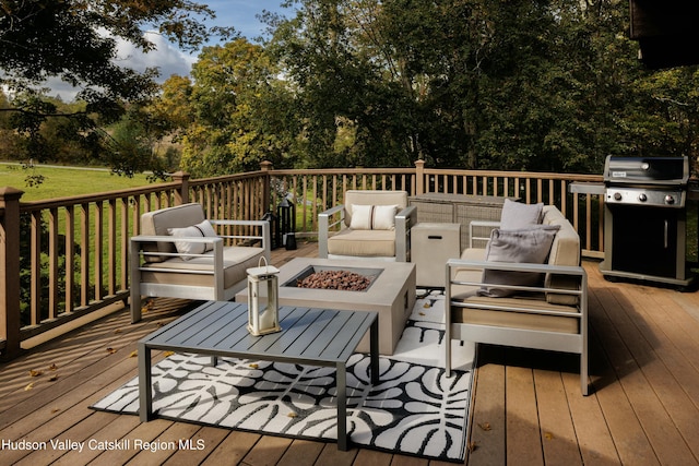 deck featuring a grill and an outdoor living space with a fire pit