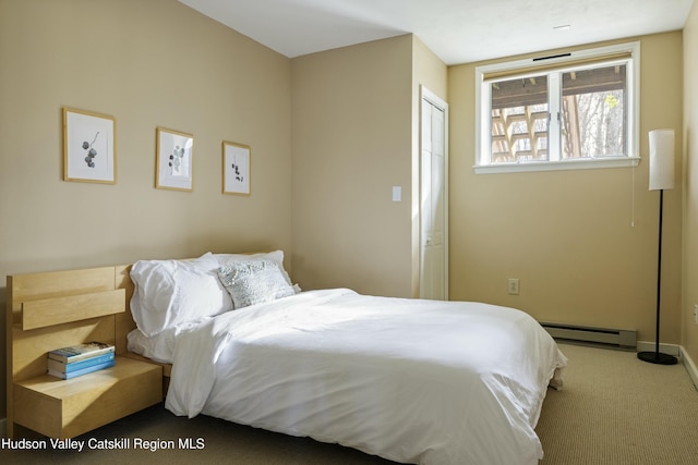 bedroom with carpet and a baseboard radiator