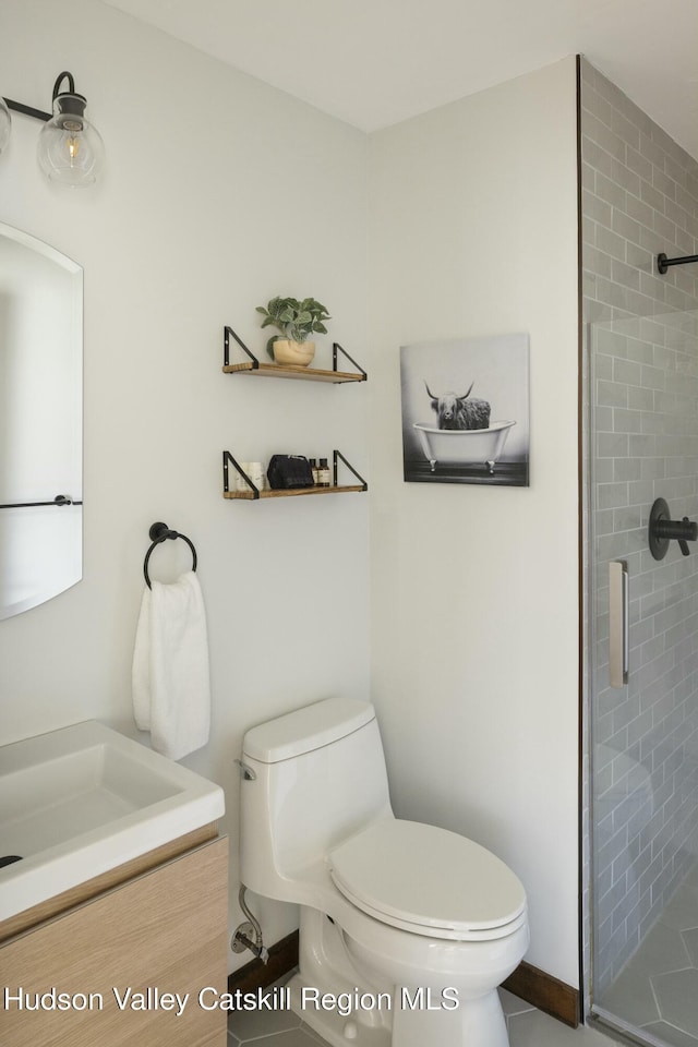 bathroom featuring tile patterned floors, vanity, toilet, and walk in shower