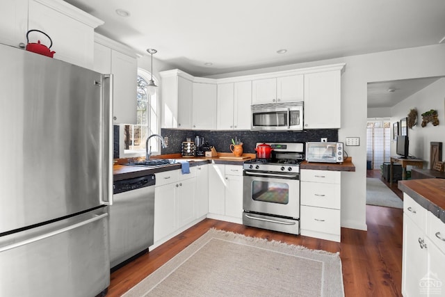 34 Cottonwood Rd, Elizaville, NY 12523 - kitchen featuring stainless steel appliances, a sink, dark countertops, decorative backsplash, and white cabinetry