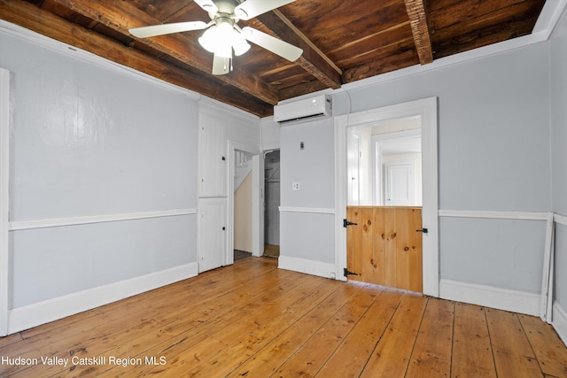 interior space featuring wood ceiling, ceiling fan, light hardwood / wood-style floors, an AC wall unit, and beamed ceiling