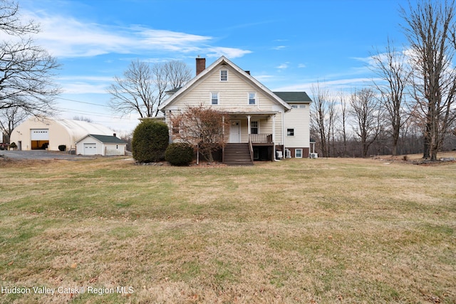 back of house with a porch and a yard