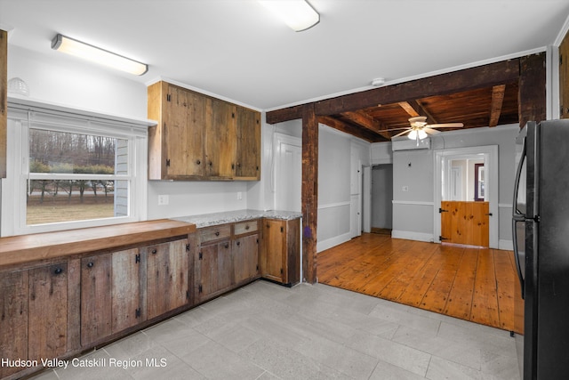 kitchen with ceiling fan, wood ceiling, beamed ceiling, and black fridge