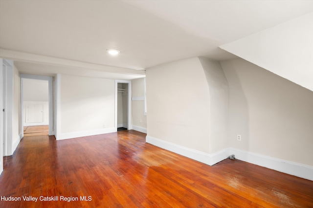 additional living space featuring dark hardwood / wood-style floors