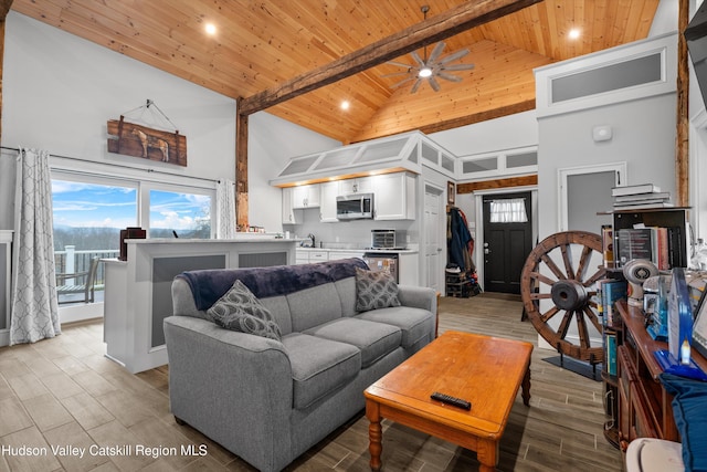 living room with ceiling fan, beam ceiling, high vaulted ceiling, and wooden ceiling