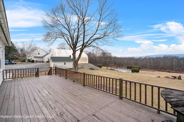 wooden deck featuring a yard