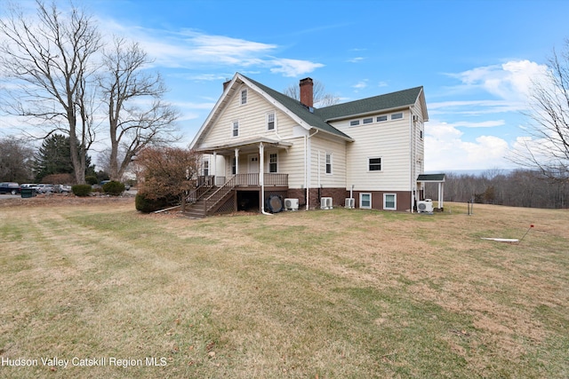 rear view of property with a porch and a yard