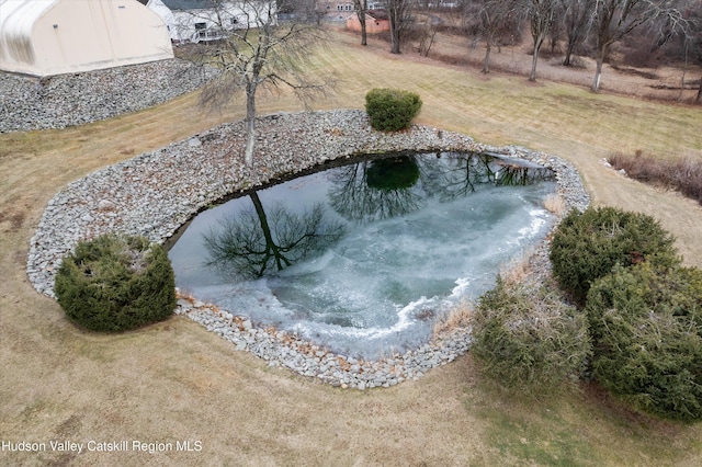 view of swimming pool with a rural view and a lawn