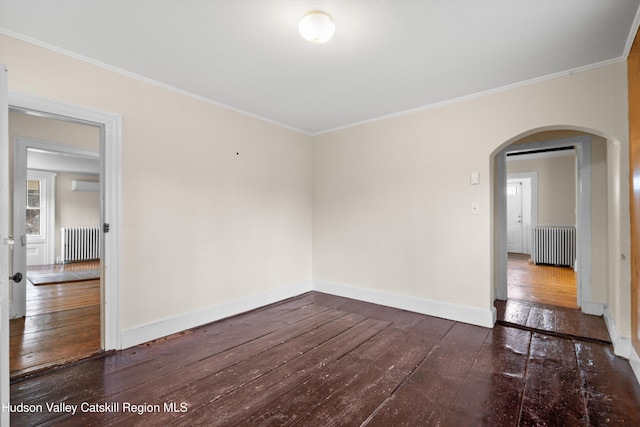 empty room featuring ornamental molding, dark hardwood / wood-style flooring, and radiator