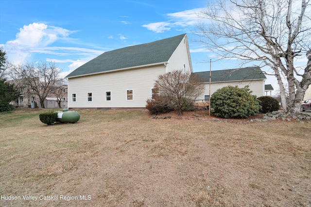 view of side of home with a yard