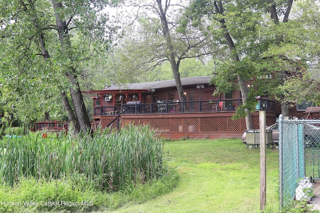 view of yard with a deck and fence