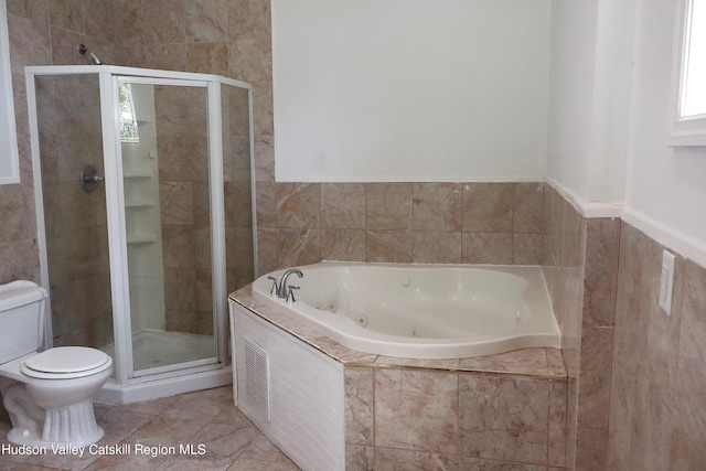 full bathroom featuring toilet, tile walls, tile patterned floors, a tub with jets, and a stall shower