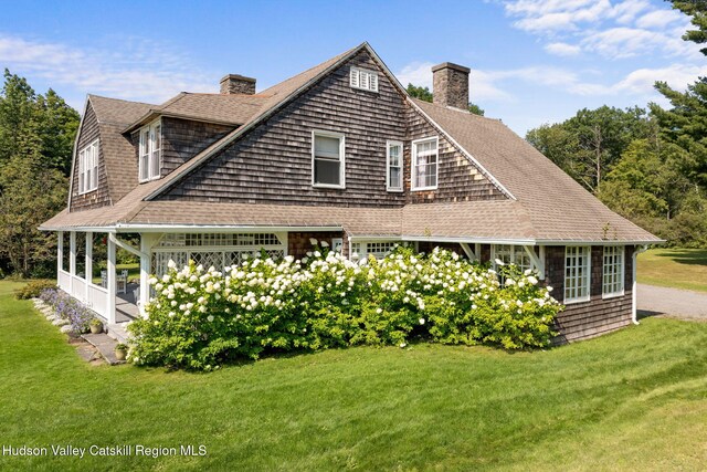 view of side of home featuring a lawn