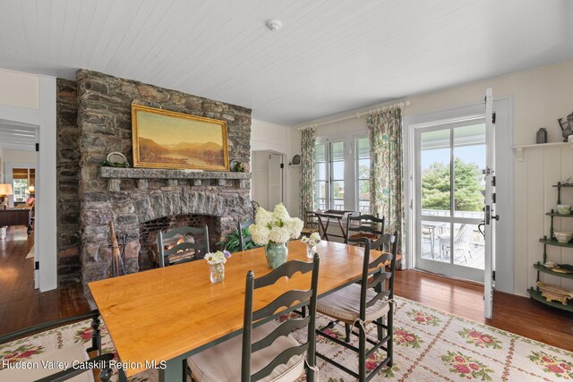 dining area featuring a fireplace and hardwood / wood-style flooring