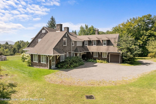 cape cod-style house with a garage and a front lawn