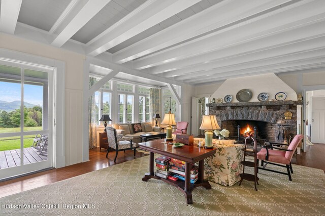 sunroom featuring a fireplace and beam ceiling