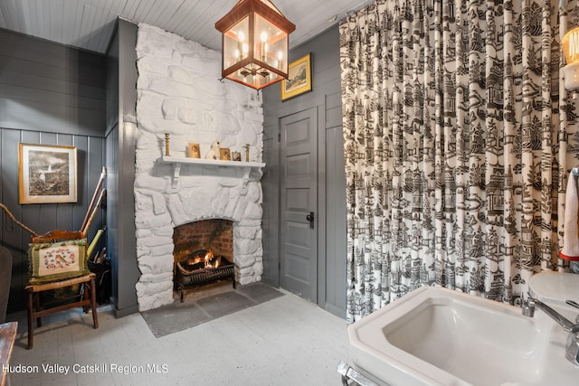 bathroom with a stone fireplace