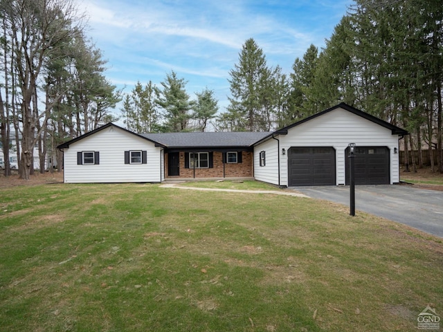 single story home featuring a garage, driveway, a front yard, and brick siding