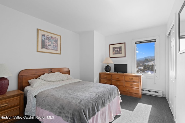 bedroom featuring a baseboard radiator and dark colored carpet