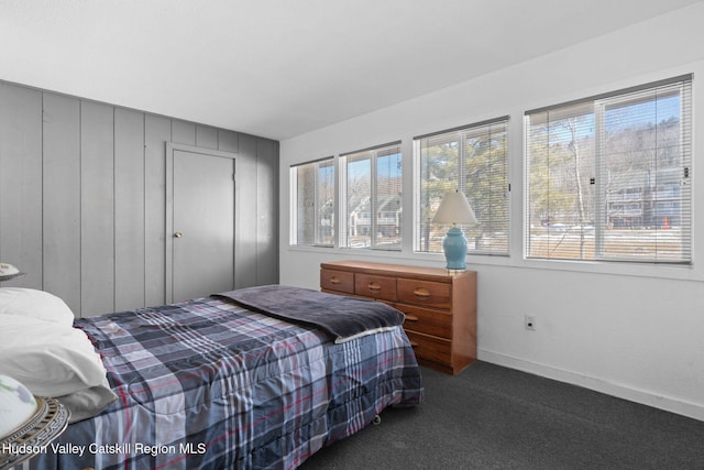 bedroom with carpet flooring and baseboards