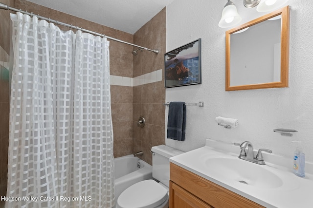 bathroom with shower / tub combo, a textured wall, vanity, and toilet