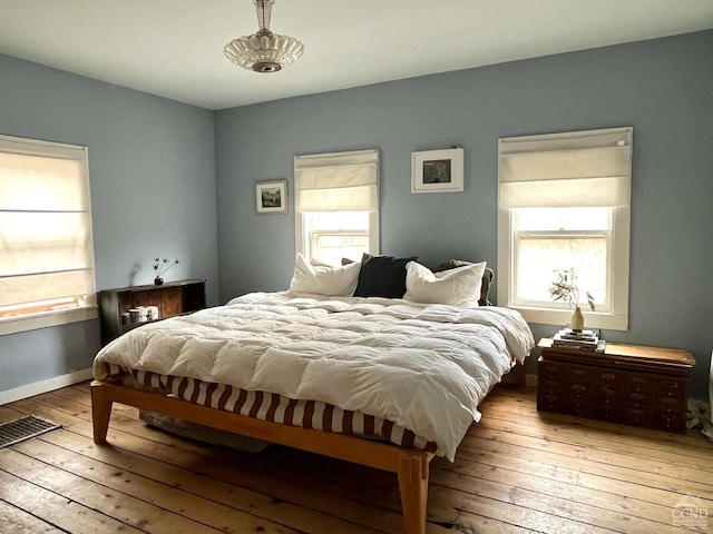 52 Church St, Philmont, NY 12565 - bedroom with hardwood / wood-style flooring and multiple windows