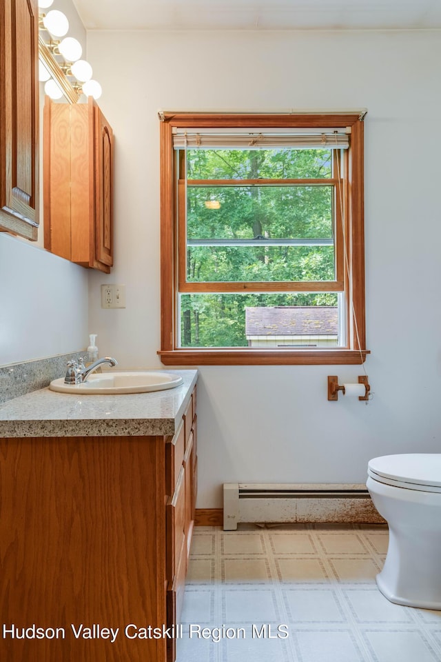 bathroom featuring vanity, a baseboard radiator, and toilet