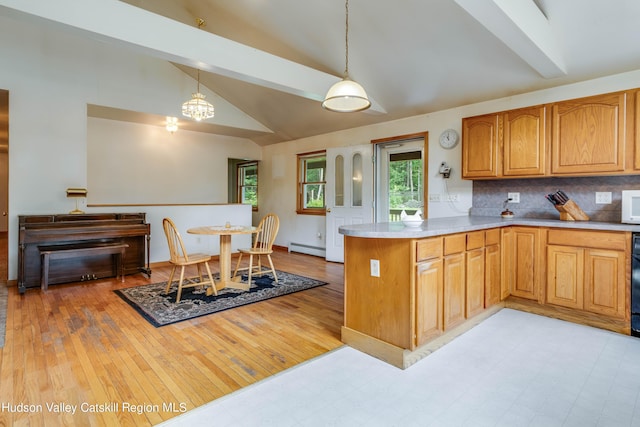 kitchen with vaulted ceiling, light wood-type flooring, baseboard heating, decorative light fixtures, and kitchen peninsula