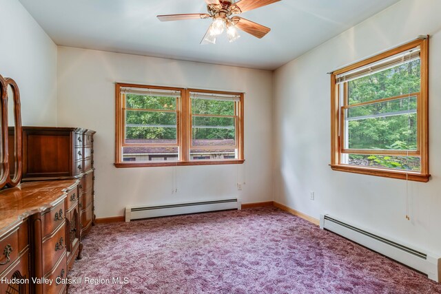 unfurnished room with light colored carpet, a wealth of natural light, and a baseboard heating unit