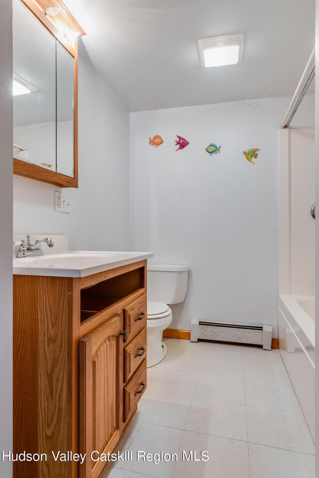 full bathroom featuring vanity, a baseboard heating unit, tile patterned floors, washtub / shower combination, and toilet