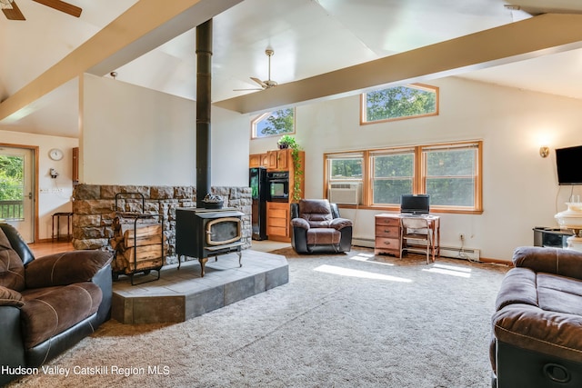 living room with a wood stove, ceiling fan, and high vaulted ceiling