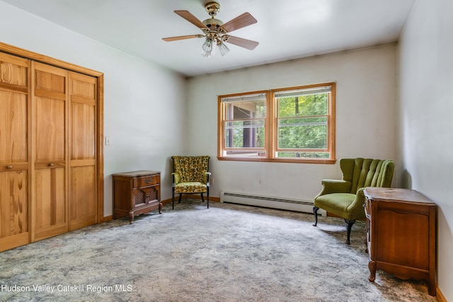 sitting room featuring carpet flooring, a baseboard radiator, and ceiling fan