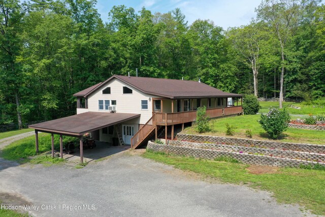 farmhouse-style home featuring a carport and a front lawn