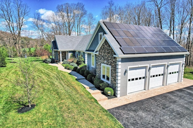 52 Hadley Dr, New Baltimore, NY 12087 - view of front of property with stone siding, a front yard, solar panels, stucco siding, and a shingled roof