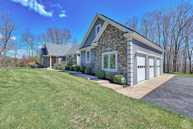 52 Hadley Dr, New Baltimore, NY 12087 - view of front of house with stone siding, a front lawn, asphalt driveway, and stucco siding