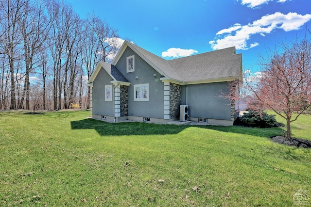 52 Hadley Dr, New Baltimore, NY 12087 - rear view of house featuring a lawn, stucco siding, roof with shingles, and stone siding