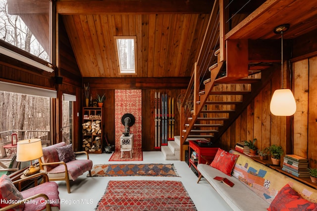 living area with high vaulted ceiling, wood ceiling, wood walls, and stairs