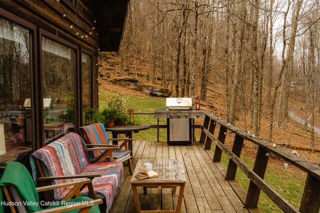 wooden terrace with area for grilling