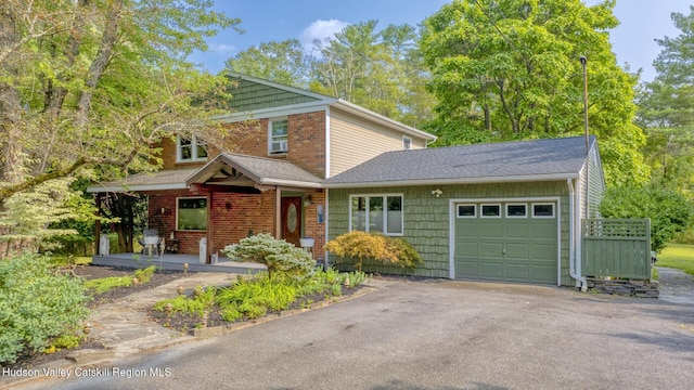 view of front of home with a porch and a garage