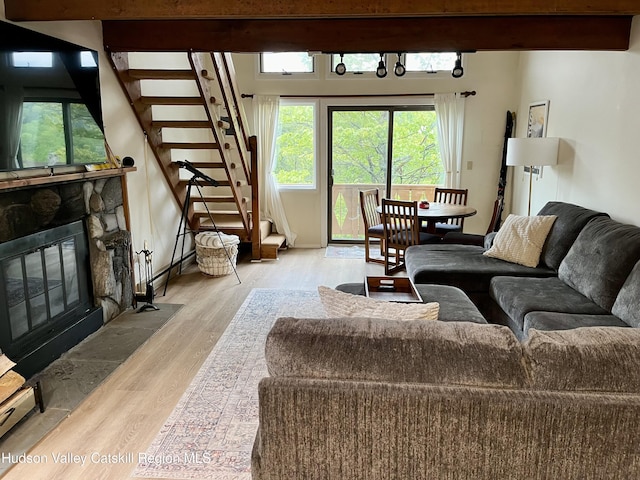 72 Hunter Dr Unit L-1, Hunter, NY 12442 - living room featuring stairway, wood finished floors, plenty of natural light, and a fireplace