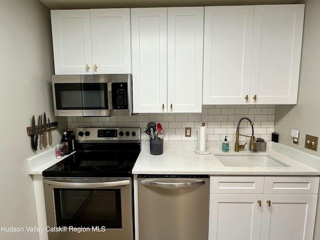 72 Hunter Dr Unit L-1, Hunter, NY 12442 - kitchen with appliances with stainless steel finishes, tasteful backsplash, and white cabinetry