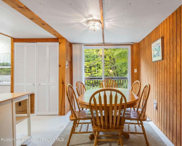 315 Begley Rd, Windham, NY 12496 - dining space with wooden walls and a textured ceiling